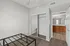 Inviting bedroom features a plush carpet, mirrored closet, and an ensuite bathroom with modern fixtures.