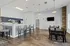 Chic communal area with a modern kitchen, stylish breakfast bar, and elegant dining table, perfect for entertaining.