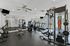 Modern fitness center with state-of-the-art equipment, including treadmills, weight benches, and a multi-gym machine, designed for an active lifestyle.