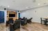Contemporary home theater room with plush seating, modern wooden flooring, and an entertainment center, ideal for comfortable and stylish movie nights.