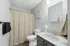Elegant bathroom design featuring a modern sink with granite countertop, stylish wall art, and a serene atmosphere.