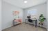 Bright and modern home office with a colorful cabinet, stylish desk setup, and lush indoor plant, creating a perfect workspace ambiance.