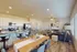 Bright and inviting open-concept living space featuring a modern kitchen with bar seating, a cozy living room with stylish decor, and ample natural light.