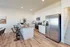 Contemporary kitchen with sleek stainless steel appliances, elegant countertops, and bar seating, perfect for entertaining.