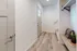 Welcoming entryway with elegant wooden flooring, stylish shelving, and modern lighting, perfect for a contemporary home.