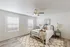 Bright and inviting bedroom with stylish decor, featuring natural light, elegant furnishings, and warm ambiance.