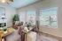 Bright and cozy living room featuring modern gray sofas, stylish decor, and abundant natural light through large windows.