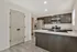 Modern kitchen with sleek stainless steel appliances, elegant dark cabinetry, and a spacious island ideal for entertaining.