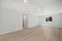 Bright, spacious living area with sleek wooden flooring and modern recessed lighting, offering a blank canvas for your dream interior.