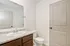 Elegant bathroom with modern fixtures, featuring a spacious countertop, sleek mirror, and pristine toilet, offering a fresh and inviting atmosphere.