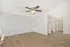 Bright open-concept living space featuring elegant laminate flooring and modern ceiling fan, ideal for a cozy home ambiance.