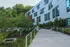Contemporary apartment exterior with sleek architecture and lush garden pathways.