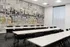 Modern conference room with stylish mural, featuring sleek tables and comfortable chairs, perfect for productive meetings.