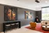Modern living area with vibrant art, stylish seating, and floor-to-ceiling windows offering a bright and inviting space.
