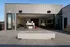 Contemporary rooftop patio featuring open-air lounge area with sleek modern furnishings and stylish interior opening to a chic bar.