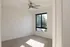 Bright and airy room with plush carpet, sleek ceiling fan, and large window with lush tree views.