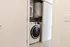 Modern laundry nook with a sleek front-load washing machine cleverly tucked behind sliding doors.