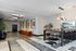 Elegant lobby with modern lighting, stylish seating, and chic decor, featuring contemporary art and greenery accents.