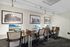 Modern, stylish workspace with sleek desks and comfortable chairs, enhanced by scenic desktop screens and vintage artwork, perfect for productivity and creativity.
