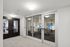 Modern business center with sleek design, featuring glass doors and a well-equipped conference room.