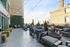 Chic outdoor terrace with stylish seating, ambient string lights, and green ivy wall, perfect for social gatherings.