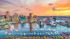 Breathtaking waterfront cityscape at sunset with vibrant downtown skyline and serene marina, ideal for city living and scenic views.