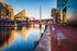 Stunning waterfront view featuring modern architecture, a picturesque bridge, and a vibrant, scenic promenade.