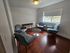 Cozy and well-lit sitting area with stylish armchairs, a modern round table, and large window, perfect for relaxation.