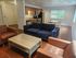 Inviting open-concept living space featuring modern kitchen, cozy seating area, and natural light.