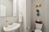 half bath with pedestal sink and mirror
