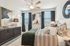 furnished primary bedroom with windows and ceiling fan