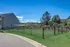 Serene fenced backyard with shaded picnic area and lush green views, perfect for relaxation and outdoor enjoyment.