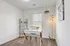Bright and inviting home office with stylish decor, modern desk, and ample natural light from a large window.