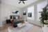 Elegant bedroom with modern artwork, cozy bedding, large windows, and chic decor for a serene atmosphere.