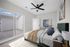Bright and airy bedroom with modern ceiling fan, large sliding glass doors, and stylish decor, offering a serene retreat.