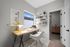 Cozy home office with stylish desk, bright yellow lamp, and contemporary shelving, offering a bright, inspiring workspace.