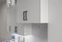 Sleek modern kitchen cabinetry with minimalist black handles and chic marble backsplash.