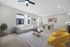 Modern living and dining area featuring a cozy white sofa, elegant coffee table, vibrant yellow chairs, and inviting dining set, illuminated by natural light through large windows.