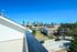 Breathtaking rooftop view showcasing a vibrant city skyline under a clear blue sky, ideal for urban living enthusiasts.