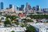 Vibrant cityscape view with modern skyscrapers and lush greenery showcasing prime urban living.