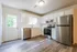 Bright and spacious kitchen with modern stainless steel appliances and elegant white cabinetry.