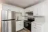Modern kitchen with sleek stainless steel appliances, elegant white cabinetry, and a stylish backsplash.