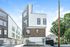 Modern multi-story apartment building with sleek design, large windows, and a stylish wood and white exterior, ideal for urban living.