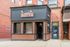 Charming storefront with vintage appeal featuring Cornish Pasty Company, nestled in a historic brick building with inviting warm tones.