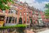 Charming historic building with classic red brick facade and ornate architectural details, perfect for urban living.