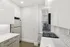 Modern kitchen with sleek white cabinets, elegant subway tile backsplash, and a compact, efficient layout.