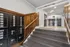Inviting apartment entrance showcasing elegant wooden paneling, secure mailboxes, and a stylish glass door entry.