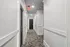 Bright and stylish apartment hallway with modern lighting and elegant design.