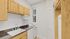 Charming kitchen with elegant wooden cabinetry, sleek countertops, and modern appliances, bathed in natural light.