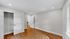 Bright and spacious bedroom with sleek hardwood flooring, ample closet space, and modern lighting.